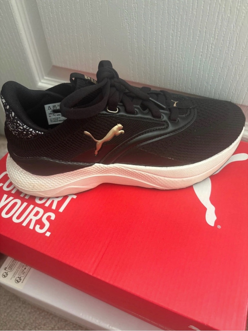 Puma Black Athletic Sneakers with White Midsole and Gold Logo
